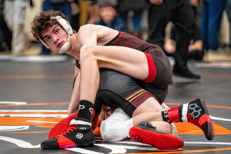 Concord’s Jaxon Carter looks to his coach during the 144-pound title bout against Portsmouth’s Stephen Whisler at the Keene Minickiello Holiday Wrestling Tournament on Saturday. Carter finished runner-up at 144, helping Concord win the team title.