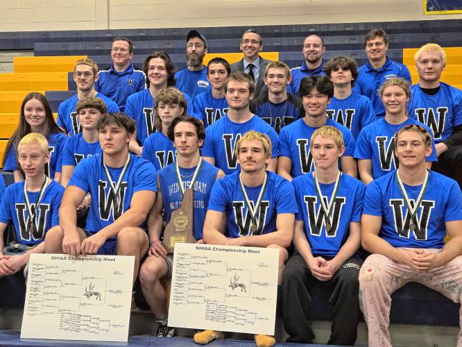 The Winnisquam wrestling team poses with its hardware after finishing second at the Division III wrestling championship on Saturday at ConVal Regional High School.