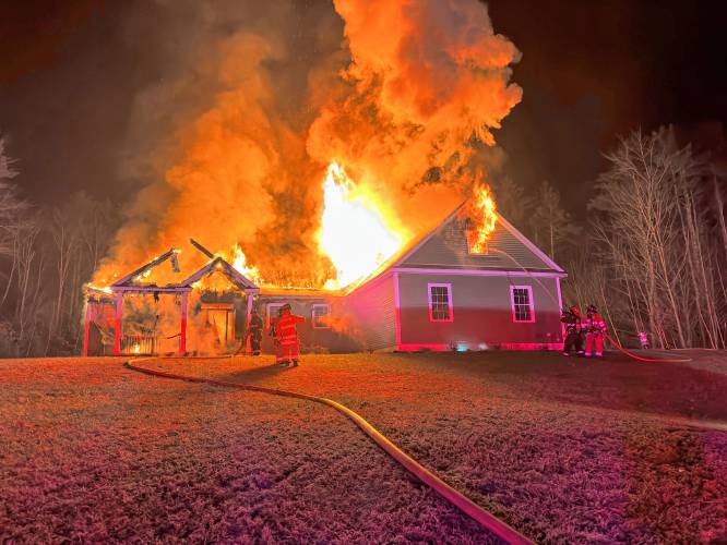 Rick and Cindy Buck’s home in Hopkinton was engulfed in flames on Wednesday evening.