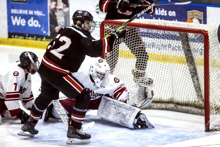 Bedford forward Javin Manfield starts to celebrate the game-winning goal as Concord goalie Kalan Gaudreault reaches in vain to stop the puck in last year’s Division I semifinal at Manchester’s JFK Arena on March 8. The loss ended Concord’s streak of three consecutive championships.
