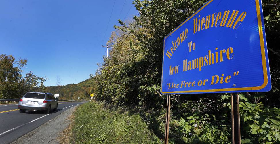 In this Thursday Oct. 8, 2015, photo, a sign welcoming visitors in both English and French is seen across the border from Vermont in Cornish, N.H. (AP Photo/Jim Cole)