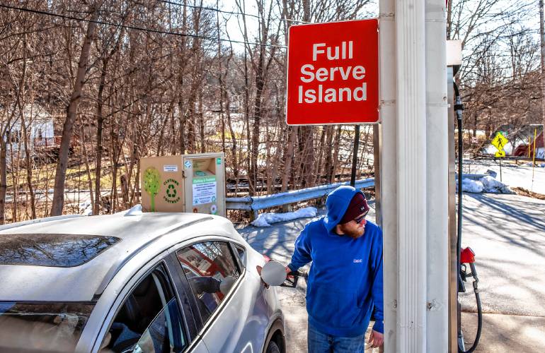 Derek Contarino pumps gas at the full service pump on Tuesday, February 20, 2023. Contarino has been working on and off at the East Concord Mobil and Auto Repair for the last 14 years, helping owner Fadi Sarkis with pumping gas and helping with repairs at the full service station right off of exit 16 in Concord.