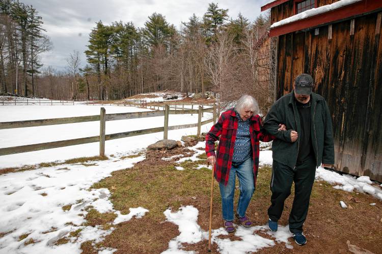 Roy Plisko walks with his mother, Virginia LaPlante outside his mother’s barn at her farm in Canterbury on Wednesday, March 27, 2024. New Hampshire Horse Council’s Board of Directors named LaPlante New Hampshire's 2024 Horse Person of the Year.