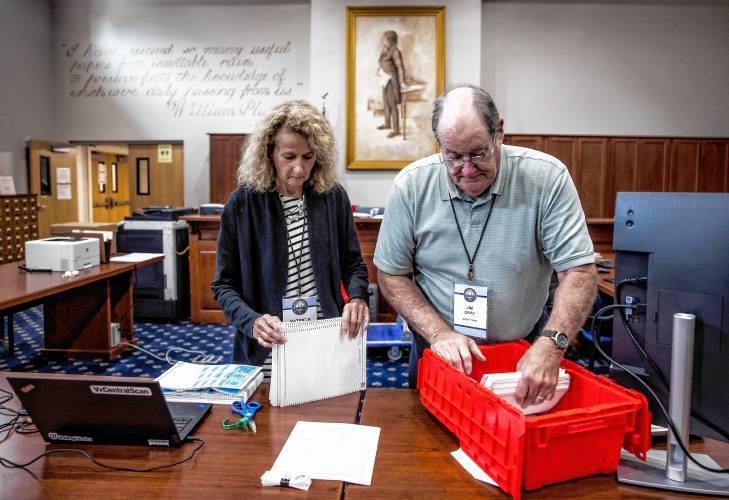 Senior Deputy Secretary of State Patricia Lovejoy (left), along with audit team member Jim Gray prepare the ballots from Winchester to be fed into the high speed scanner at the State Archives in Concord on Wednesday, September 11, 2024.