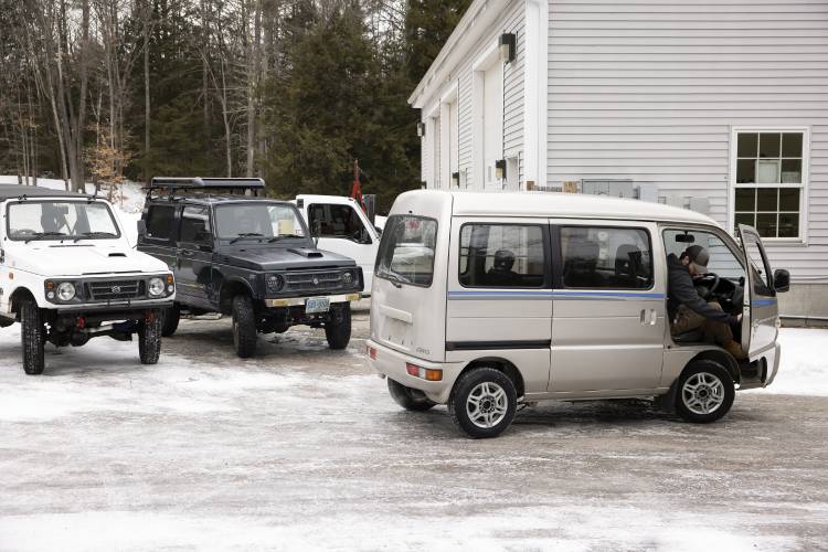 Granite State Imports co-owner Dylan Beckerman steps out of one of the minivans at the lot for their kei vehicles in Hopkinton on Jan. 31, 2025.