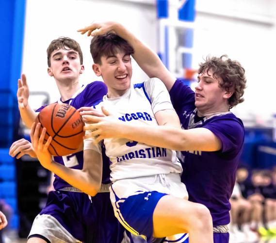 Concord Christian center Ben Whitten (center) and Groveton forward Hunter Parks (right) fight for a rebound during first half action on Thursday night.