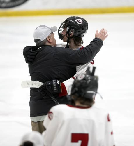 Concord hockey coach Dunc Walsh and Brooks Craigue hug after a season-ending loss to Bedford in overtime in the Division I semifinals on March 8. Craigue, last year’s D-I Player of the Year, graduated, leaving the Crimson Tide with some questions entering this season.