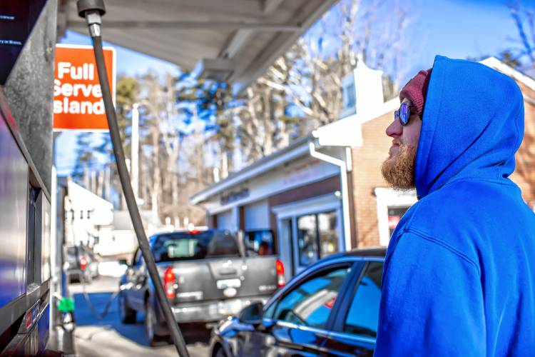 Derek Contarino pumps gas at the full service pump on Tuesday, February 20, 2023. Contarino has been working on and off at the East Concord Mobil and Auto Repair for the last 14 years, helping owner Fadi Sarkis with pumping gas and helping with repairs at the full service station right off of exit 16 in Concord.