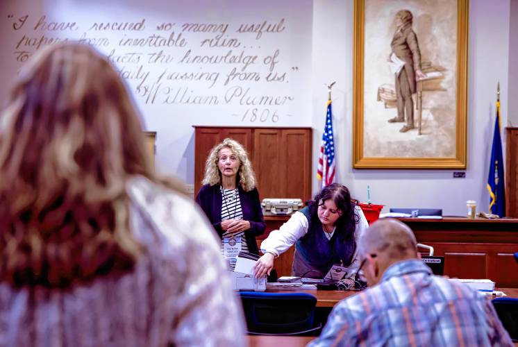 Senior Deputy Secretary of State Patricia Lovejoy (left), along with Assistant Secretary of Stare Jennifer Cote answere questions for the audit team as they prepare the ballots from Winchester to be fed into the high speed scanner at the State Archives in Concord on Wednesday, September 11, 2024.