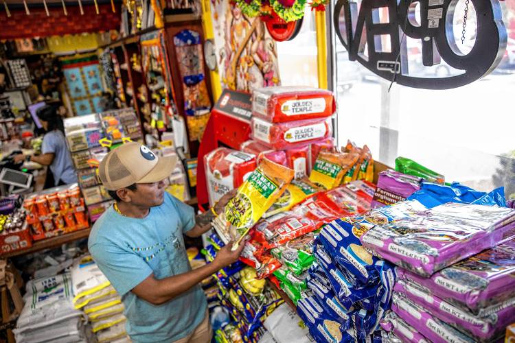 Karma Gonpo has the shelves stocked with items that customers will find familiar from their native countries at the Katmandu Bazaar Market on Loudon Road in Concord.