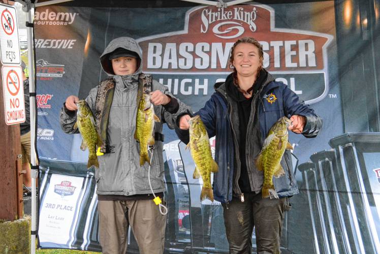 Coe-Brown Northwood Academy’s Sam Gauvin (left) and Liz Abernathy (right) pose with their catch at the bass fishing state qualifying tournament on Lake Winnipesaukee on Thursday. Coe-Brown’s total catch of 14.9 pounds was good for 10th place, enough to qualify for the state championship. The championship will be held on Oct. 5 at Lake Winnipesaukee.
