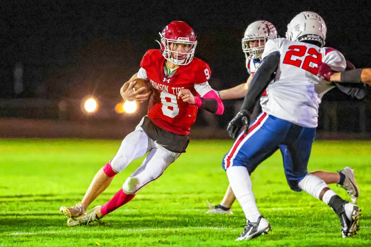 Concord quarterback Colby Nyhan (left) runs with the ball during a home game against Manchester Memorial on Thursday. Nyhan passed for 115 yards and a touchdown, ran for 63 yards and a TD and kicked all three extra points in the 21-12 victory. Concord handed the Crusaders their first loss of the season. 