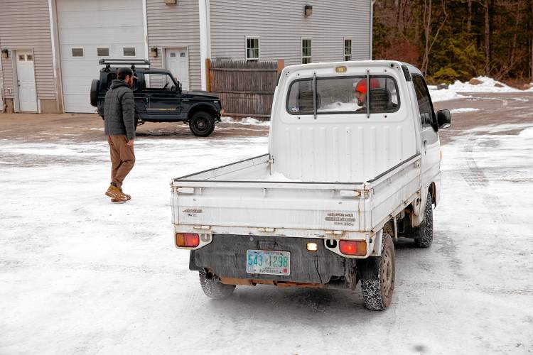 Stan Nelson (right), who co-owns Granite State Imports in Hopkinton, starts up a Subaru mini dump truck at their location on Sugar Hill Road on Friday, January 31, 2025. Nelson and co-owner Dylan Beckerman (left) import the vehicles from Japan, and they work with Village Street Garage in Penacook to get them to pass inspection, and then the pair do modifications for their clients.