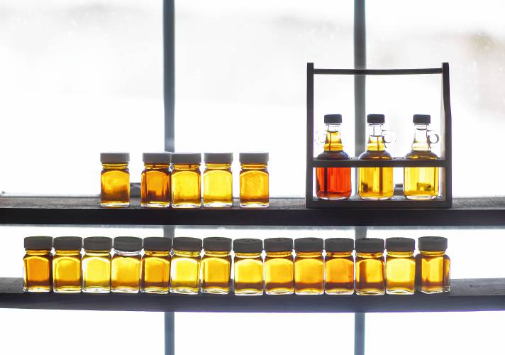 Syrup samples from Windswept Maple Farm in Loudon sit on a shelf in the window in the back room of the store. The two jars on top shelf to the left are from this year’s run. The New Hampshire Maple Weekend is this weekend. Fore more information, check https://www.windsweptmaples.com