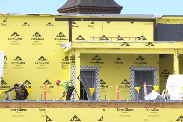 Construction of the Friendly Toast and Arts Alley in downtown Concord is taking shape as workers on the second level work on the flooring of the deck.