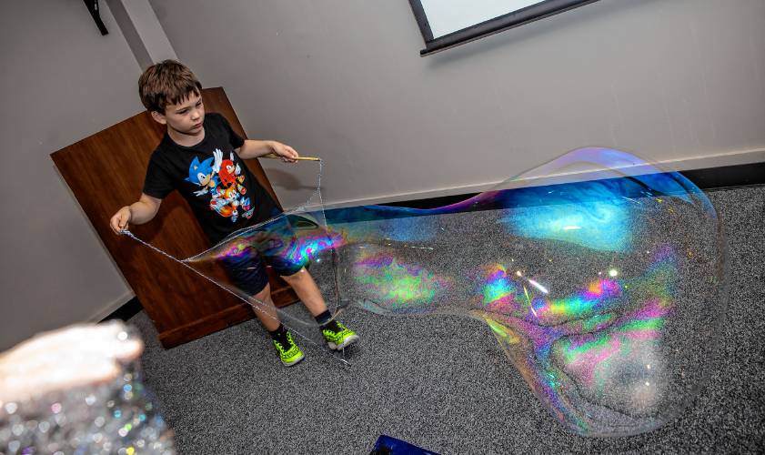 Michael Poifier creates a large bubbles at the “Mad Science” summer program at Concord Library on Aug. 27.