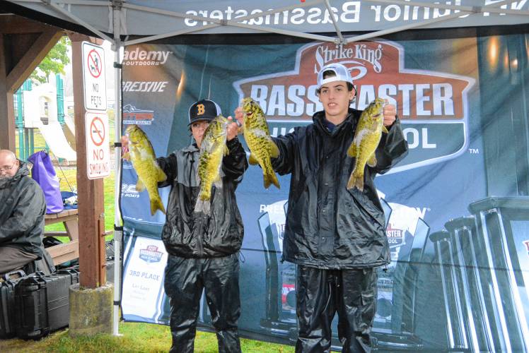 Bow’s Garrett Landers (left) and Ethan Herrick (right) pose with their catch at the bass fishing state qualifying tournament at Lake Winnipesaukee on Thursday.