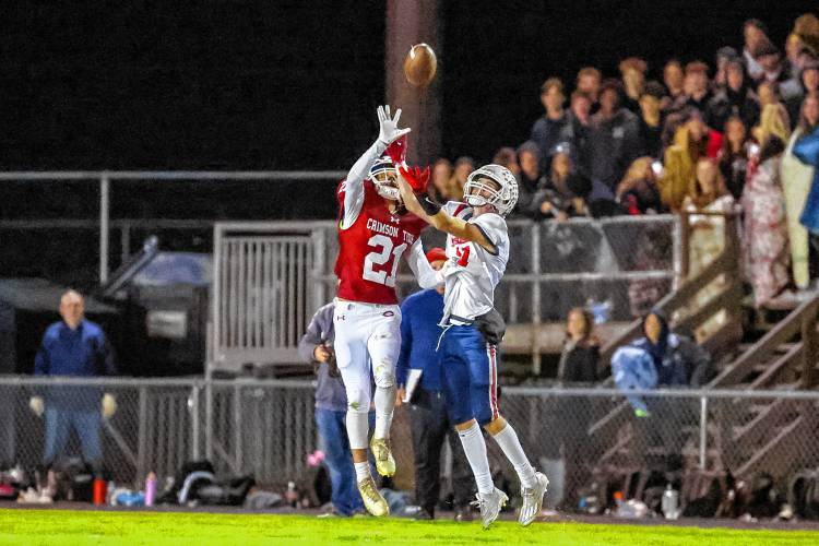Concord defensive back Angelino Rodriguez (21) tips the ball away from a Manchester Memorial receiver during a home game on Thursday. Concord’s defense had four takeaways in a 21-12 victory. The Crimson Tide handed the Crusaders their first loss of the season.