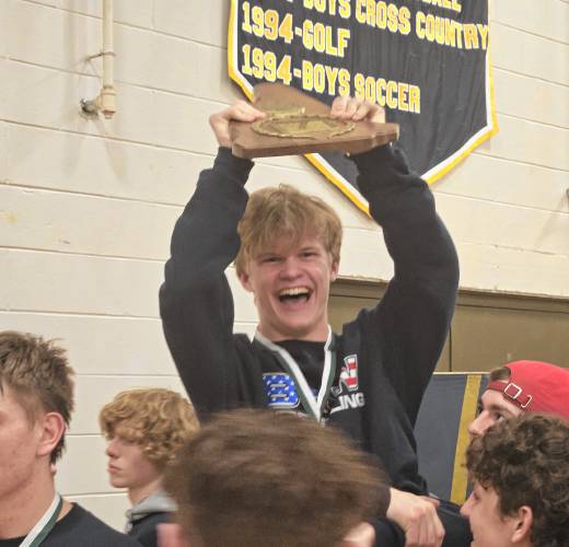 Bow junior Herbie Madden hoists the hardware after the Falcons repeated as Division III state champions on Saturday. Madden finished third at 144 pounds to help Bow’s title defense
