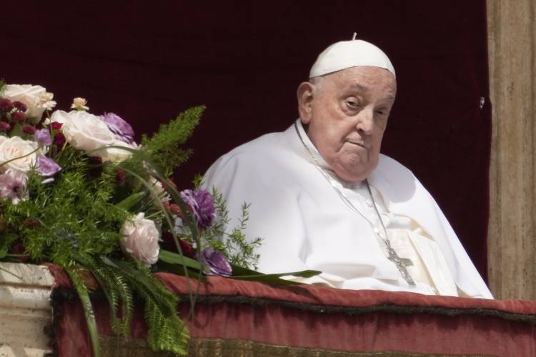 Pope Francis appears on the central lodge of St. Peter's Basilica to bestow the Urbi et Orbi (Latin for to the city and the world) blessing at the end of the Easter mass presided over by Cardinal Angelo Comastri in St. Peter's Square at the Vatican Sunday, April 20, 2025. (AP Photo/Gregorio Borgia)