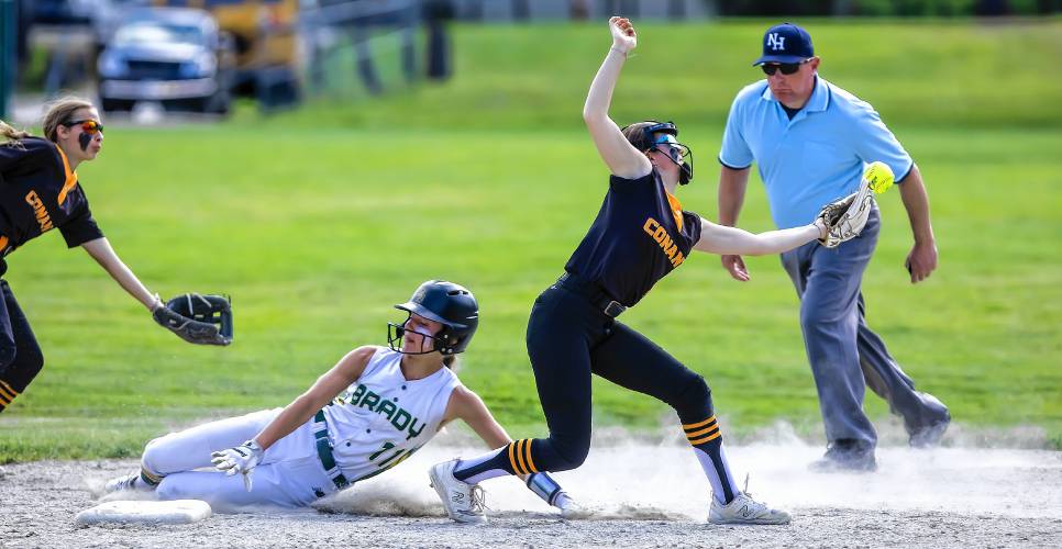 Bishop Brady baserunner Payton Bryson slides safely into second base after Conant shortstop Sophia Spingola bobbles the ball on Wednesday at Rollins Park in Concord.