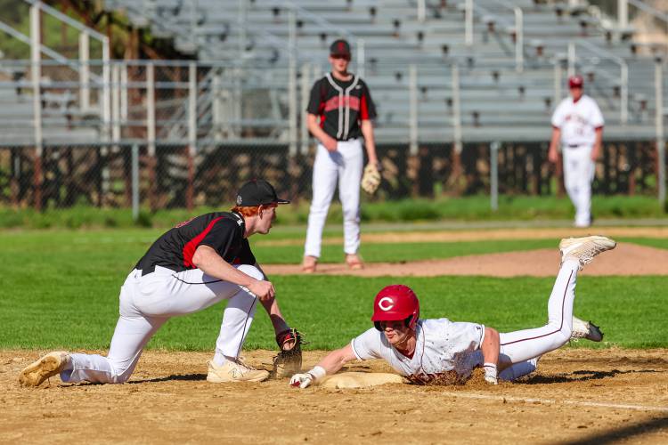 A Concord baserunner slides safely into first base during a teammate’s at bat against Bedford on Monday. A Concord baserunner slides safely into first base during a teammate’s at bat against Bedford on Monday.