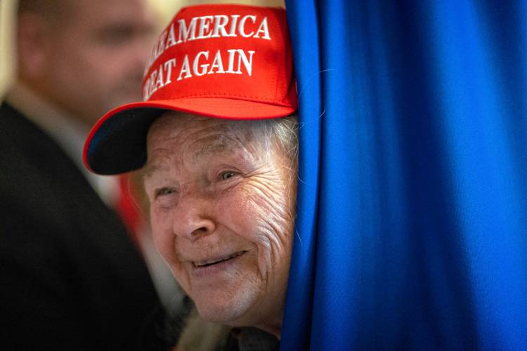 Former President Donald Trump supporter Augusta Petrone looks out from an area secured by the Secret Service at the New Hampshire Statehouse where Trump will sign papers to get on the Republican presidential primary ballot, Monday, Oct. 23, 2023, in Concord, N.H. (AP Photo/Michael Dwyer)