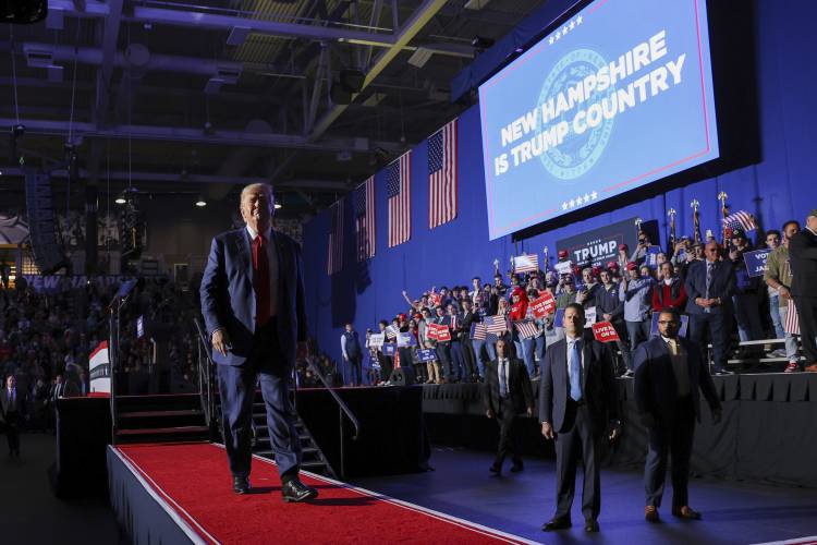 Former President Donald Trump leaves the stage at a campaign rally, Saturday, Dec. 16, 2023, in Durham, N.H. (AP Photo/Reba Saldanha)