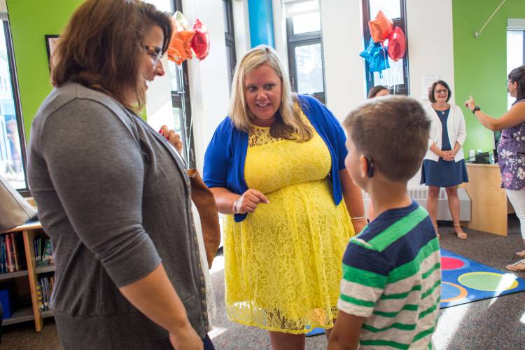 Mill Brook principal Katie Scarpati (center) talks with a mother and son during a meet and greet event at Mill Brook School in Concord on Wednesday, Aug. 8, 2018. 