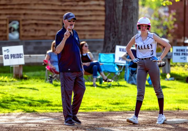 Merrimack Valley JV softball coach Tom Burke talks with baserunner Avery Snarey during a game against John Stark earlier this month. MV came back and won.