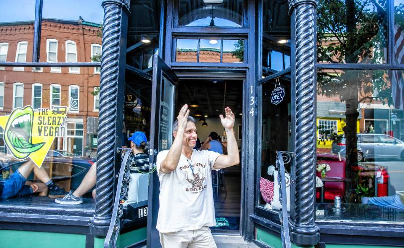 Rob Azavedo, owner of Pembroke City Limits waves to a passerby in front of the new establishment on Main Street in Pembroke on Thursday evening, July 11. Azavedo opened the new venue with a soft opening on Wednesday night.