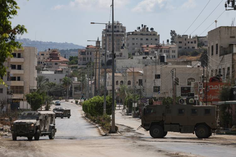 Israeli military vehicles roll down a street in the occupied West Bank city of Tulkarm on Saturday, Aug. 3, 2024. (Jaafar Ashtiyeh/AFP/Getty Images/TNS) Israeli military vehicles roll down a street in the occupied West Bank city of Tulkarm on Saturday, Aug. 3, 2024. (Jaafar Ashtiyeh/AFP/Getty Images/TNS)