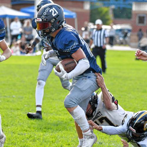 Merrimack Valley running back Reece Clermont (21) breaks a tackle during MV’s homecoming football game against Kennett on Saturday. Clermont scored four touchdowns to lead the Pride to a 28-7 victory.