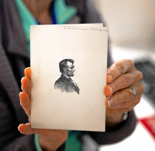 Concord Library volunteer Ginny Babczak holds up an etching of President Abraham Lincoln as she prepares to scan it in for the digital archive for the library. Babczak is a former librarian who comes in to scan materials.