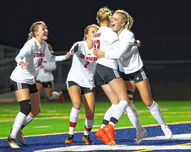 Coe-Brown celebrates Abbey Frank's (12) goal in the fifth minute of Sunday’s Division II championship game against Hollis-Brookline.