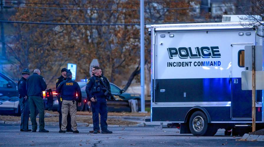 Police stand outside the police command center near New Hampshire Hospital on Friday. A State Police bomb squad responded to the scene to investigate a suspicious vehicle. The name of the victim and suspect were not identified by press time.