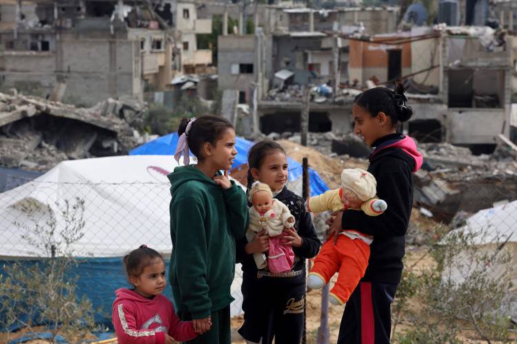 Palestinian children play in front of rubble at a makeshift camp housing displaced Palestinians in Rafah in the southern Gaza Strip on Jan. 28, 2024, amid ongoing battles between Israel and the Palestinian militant group Hamas.