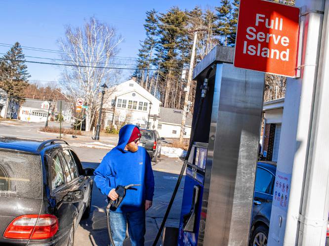 Derek Contarino pumps gas at the full service pump on Tuesday, February 20, 2023. Contarino has been working on and off at the East Concord Mobil and Auto Repair for the last 14 years, helping owner Fadi Sarkis with pumping gas and helping with repairs at the full service station right off of exit 16 in Concord.