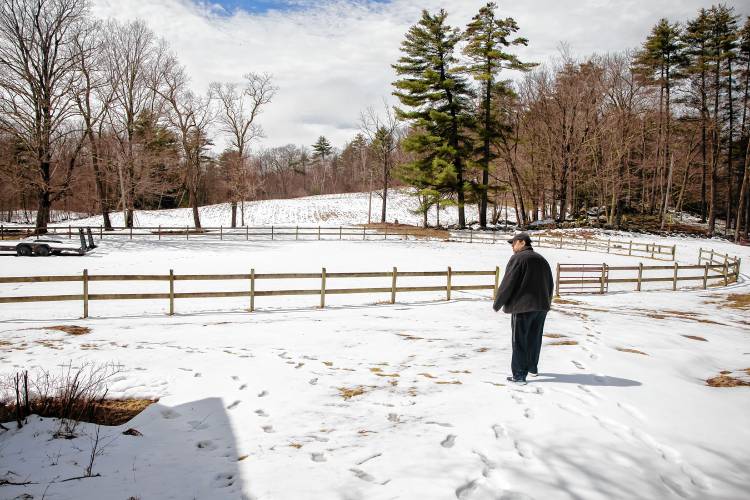 Roy Plisko walks near the horse ring at Virginia LaPlante’s farm in Canterbury on Wednesday, March 27, 2024. New Hampshire Horse Council’s Board of Directors named his mother New Hampshire's 2024 Horse Person of the Year.