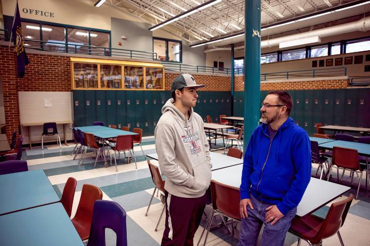 Adam Czarkowski and his son, Tyler, at Hopkinton High School after baseball practice on Wednesday. The father and son were talking about the new FAFSA forms.