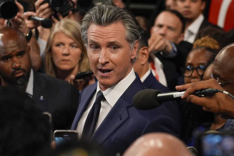 FILE - California Gov. Gavin Newsom speaks to reporters after a presidential debate between President Joe Biden and Republican presidential candidate former President Donald Trump in Atlanta, Thursday, June 27, 2024. On Saturday, June 29, 2024, Newsom signed California's budget to close an estimated $46.8 billion deficit through $16 billion in spending cuts and temporarily raising taxes on some businesses. (AP Photo/John Bazemore, File) FILE - California Gov. Gavin Newsom speaks to reporters after a presidential debate between President Joe Biden and Republican presidential candidate former President Donald Trump in Atlanta, Thursday, June 27, 2024. On Saturday, June 29, 2024, Newsom signed California's budget to close an estimated $46.8 billion deficit through $16 billion in spending cuts and temporarily raising taxes on some businesses. (AP Photo/John Bazemore, File)