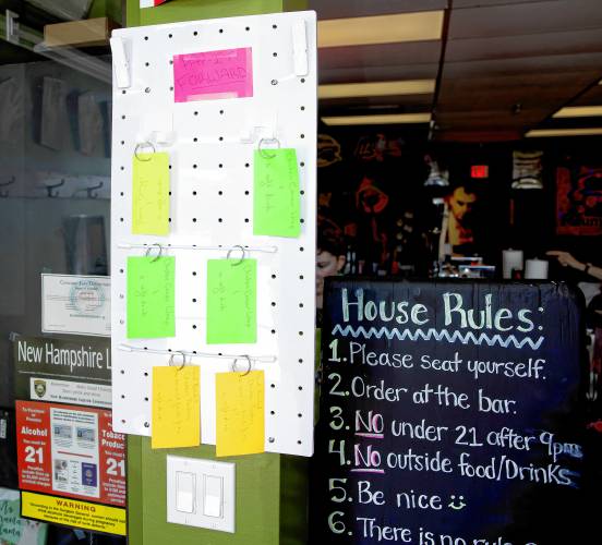 The Pay It Forward board at the entrance of the Forum Pub in Penacook.