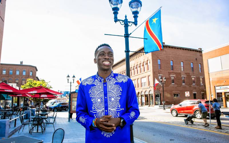 Fisto Ndayishimiye on Main Street in Concord where the sidewalks are adorned with international flags for this coming Sundayâs Multicultural Festival at Keach Park.