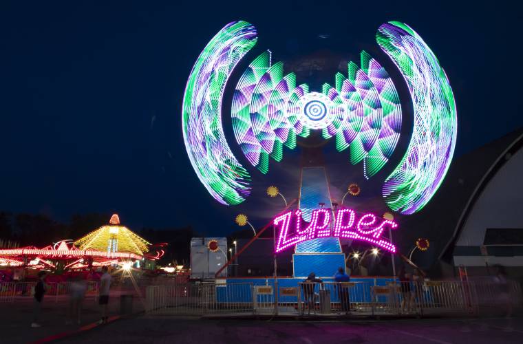 A five second exposure on a tripod shows the rides at the 64th annual Kiwanis Spring Fair at Everett Arena on Thursday evening, May 12, 2022.