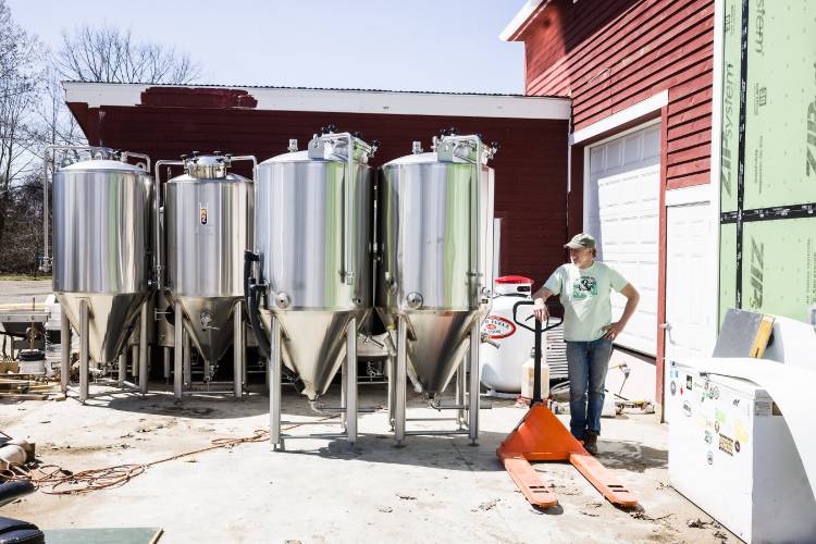 David Stewart, owner of Blasty Bough Brewing Company in Epsom, stands with some of the equipment he bought. He has actually expanded when other breweries are closing down.