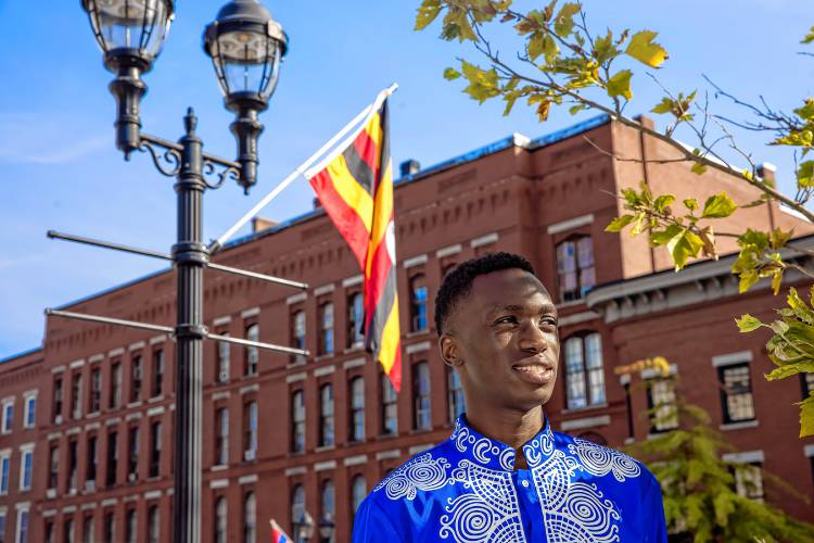 Fisto Ndayishimiye on Main Street in Concord where the sidewalks are adorned with international flags for this coming Sundayâs Multicultural Festival at Keach Park.