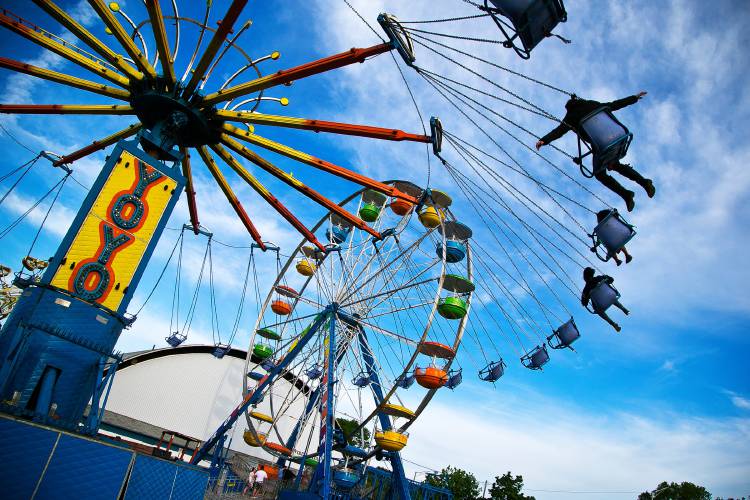 A rider spreads her arms while on the YoYo swing ride at the 60th annual Kiwanis Fair at the outdoor parking lot of Everett Arena in Concord Friday night. The fair is open today from noon until 11 p.m. and Sunday from noon until 6 p.m. In addition, there is a triple-header Roller Derby starting at 3p.m. today featuring the Granite State Roller Derby vs. The Connecticut Rollergirls, followed by matches at 5 and 7 p.m.