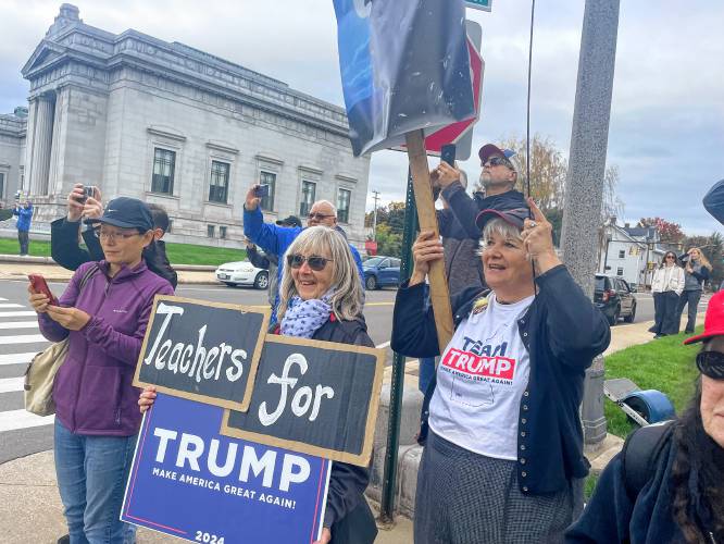 Susan Moltisanti and Kathy Holmes, right, wait for former president Donald Trump outside the New Hampshire State House on Monday. 
