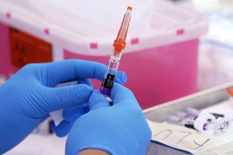 A flu vaccine is readied at a community resource center in Lynwood, Calif., on Oct. 28, 2022. 