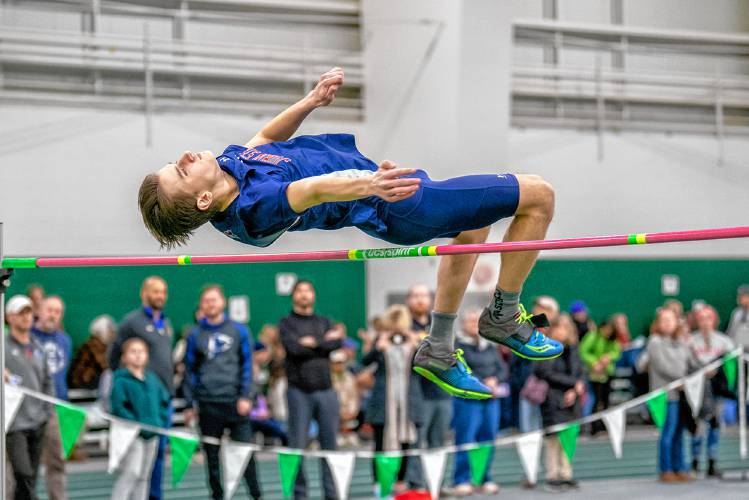 John Stark’s Rio Calle clears the high jump bar at the NHIAA Division II indoor track & field championships on Sunday at Plymouth State. Calle won the event by clearing 6-1 in a jump off and also finished second in the long jump to lead John Stark to second place as a team.